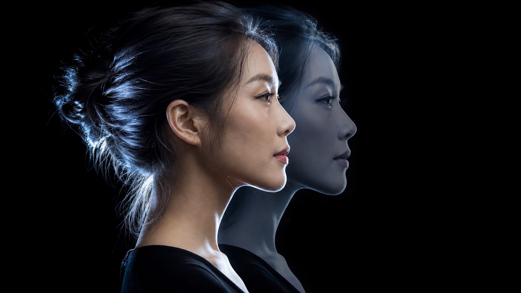Studio double-profile portrait with a transparent duplicate and silver rim light